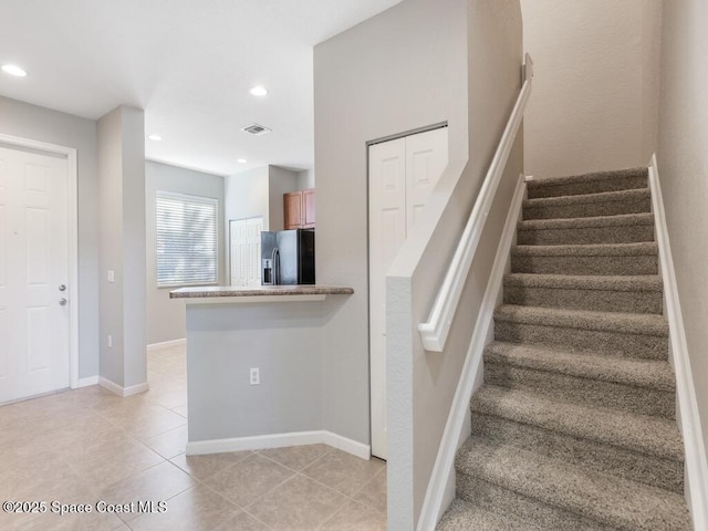 staircase with tile patterned flooring