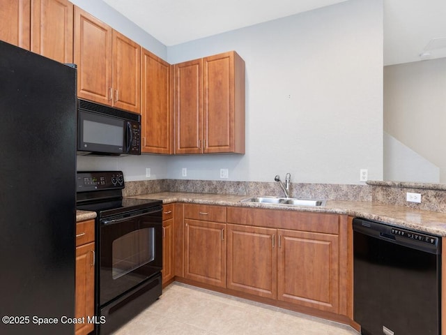 kitchen with sink, black appliances, and light tile patterned flooring