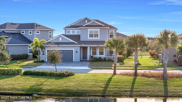 view of front of home with a garage and a front lawn