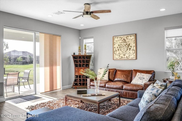 living room with ceiling fan and light wood-type flooring