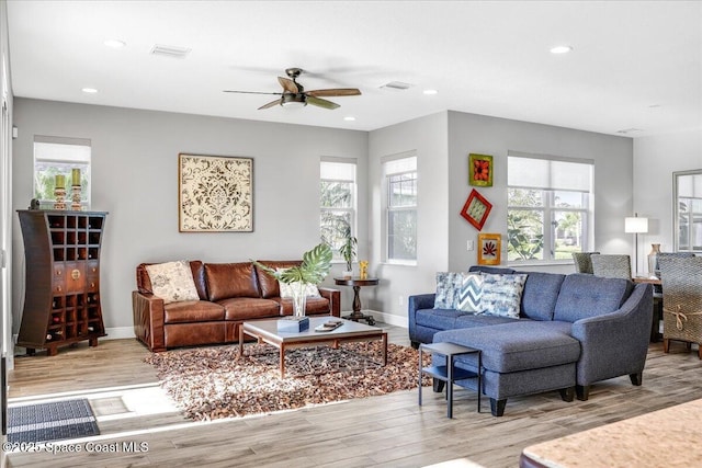 living room featuring light hardwood / wood-style floors and ceiling fan