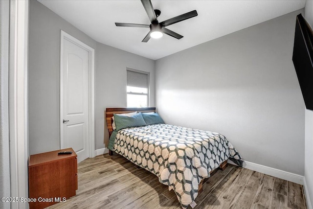 bedroom with light hardwood / wood-style flooring and ceiling fan