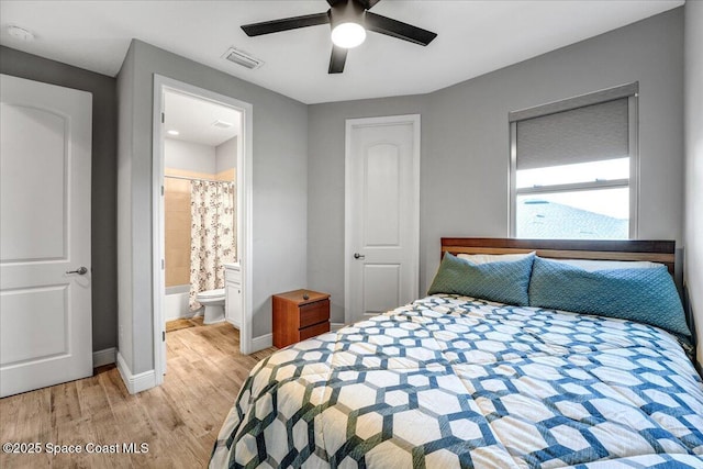 bedroom featuring ensuite bathroom, ceiling fan, and light hardwood / wood-style flooring