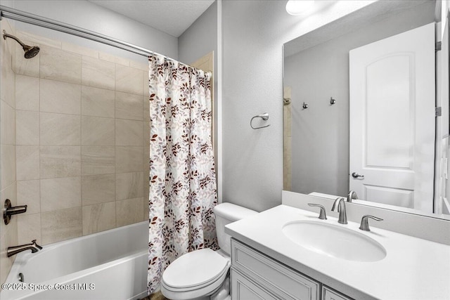 full bathroom featuring toilet, vanity, shower / bathtub combination with curtain, and a textured ceiling