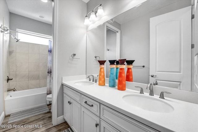 full bathroom with hardwood / wood-style flooring, vanity, toilet, and shower / bath combo with shower curtain