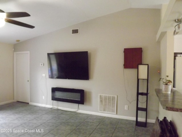 unfurnished living room with ceiling fan, lofted ceiling, and tile patterned flooring