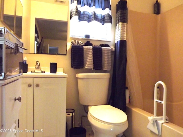 bathroom featuring shower / bathtub combination with curtain and toilet