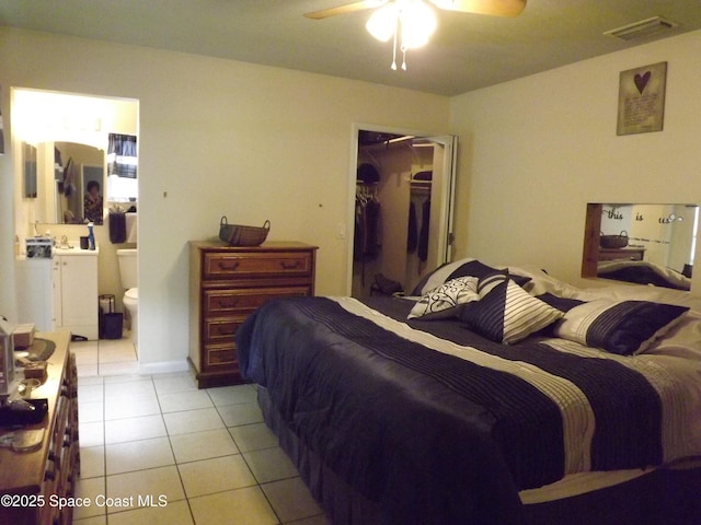 bedroom with connected bathroom, a spacious closet, a closet, and light tile patterned floors