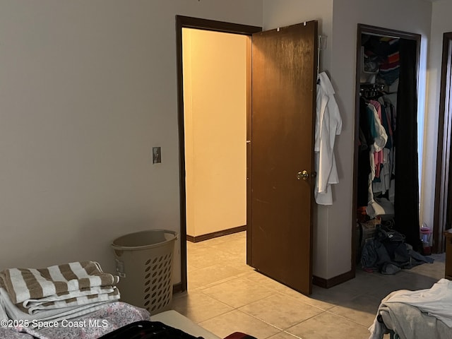 bedroom featuring light tile patterned floors and a closet