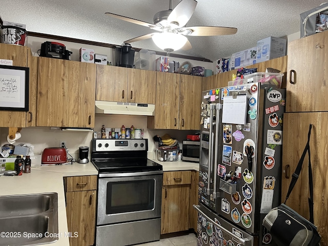 kitchen with sink, ceiling fan, stainless steel appliances, a textured ceiling, and light tile patterned flooring