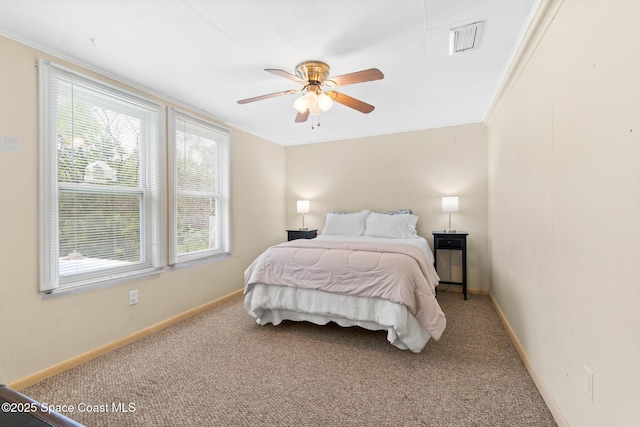 bedroom featuring ceiling fan, carpet flooring, visible vents, and baseboards