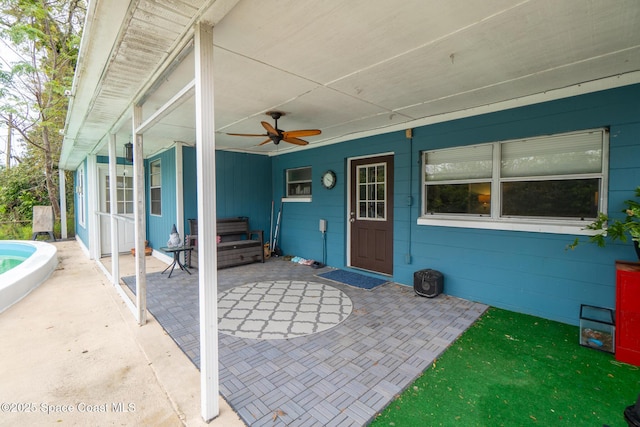 view of patio featuring a hot tub and ceiling fan