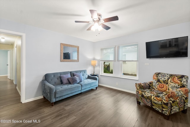 living room with dark wood-style floors, ceiling fan, and baseboards