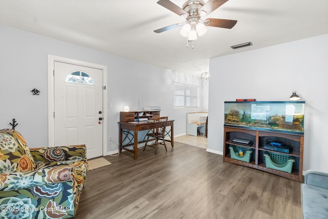 entrance foyer with visible vents, ceiling fan, baseboards, and wood finished floors