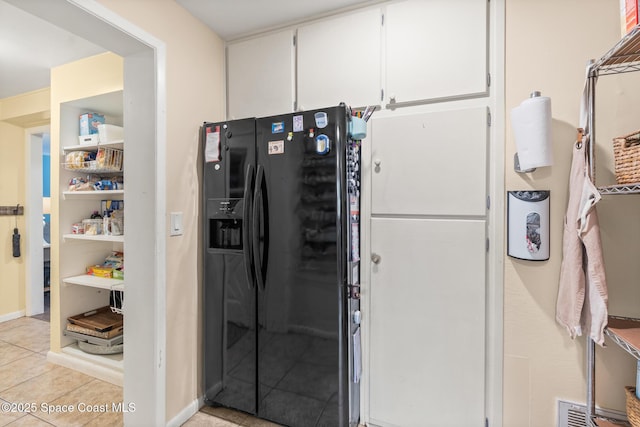 kitchen featuring light tile patterned floors, open shelves, black fridge with ice dispenser, and white cabinets