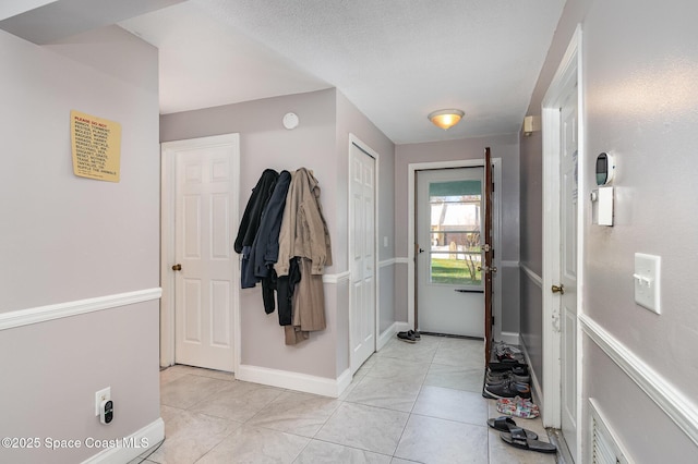 entryway with light tile patterned floors