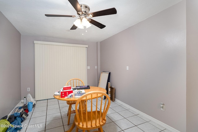 tiled dining space featuring ceiling fan