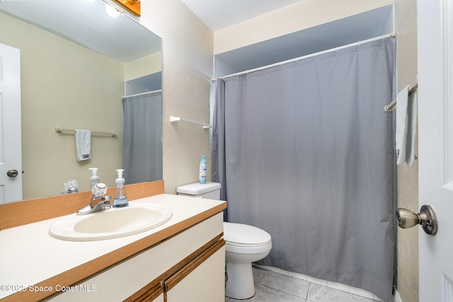 bathroom featuring tile patterned flooring, vanity, and toilet