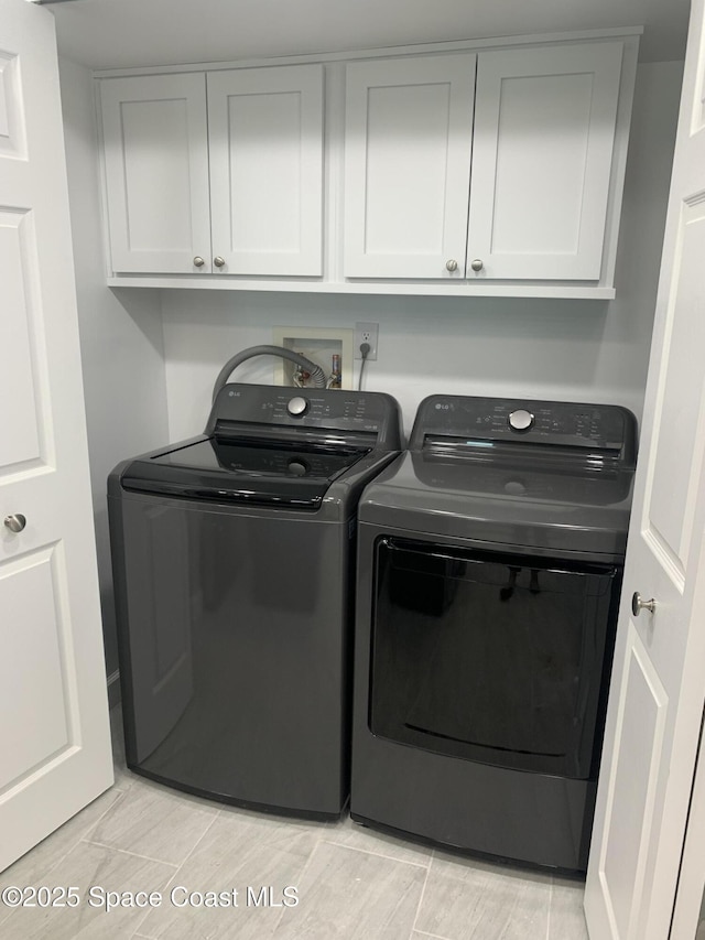 laundry area featuring cabinets and independent washer and dryer