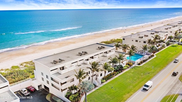 bird's eye view with a water view and a beach view