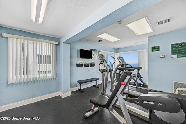 exercise room featuring a textured ceiling