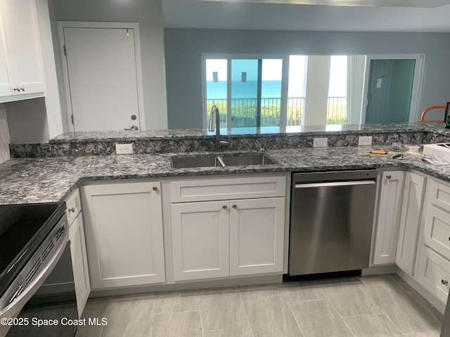 kitchen featuring white cabinetry, dishwasher, sink, and dark stone counters