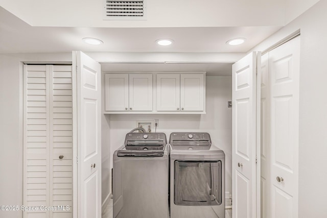 laundry room featuring cabinets and independent washer and dryer