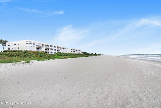 exterior space with a beach view and a water view