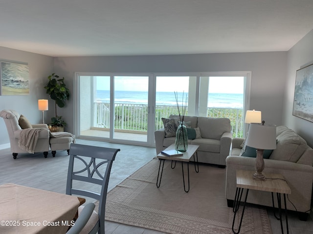 living room with a water view and light hardwood / wood-style floors