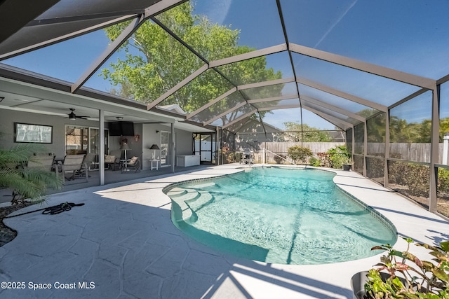 view of pool featuring ceiling fan, a patio, glass enclosure, fence, and a fenced in pool