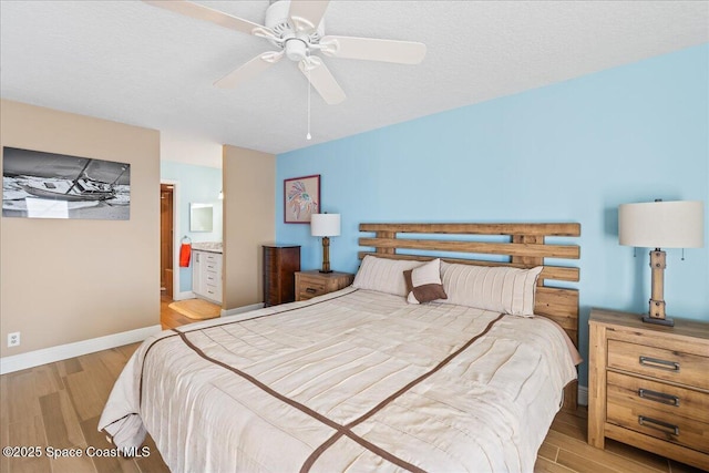 bedroom with ensuite bathroom, ceiling fan, a textured ceiling, and light hardwood / wood-style floors