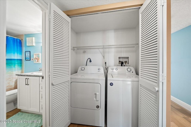 laundry room featuring light hardwood / wood-style flooring and independent washer and dryer