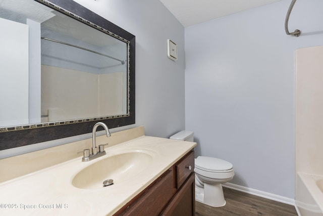 bathroom featuring vanity, wood-type flooring, and toilet