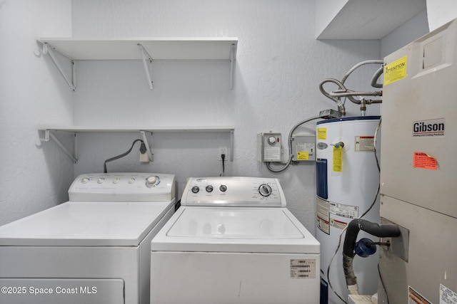 washroom featuring washer and dryer, electric water heater, and heating unit