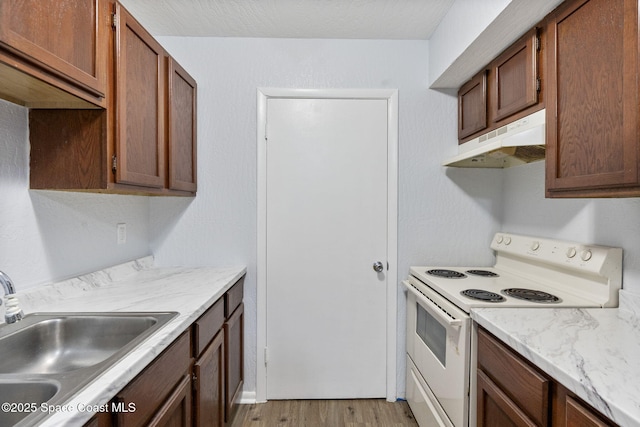 kitchen with sink, white electric range, and light wood-type flooring