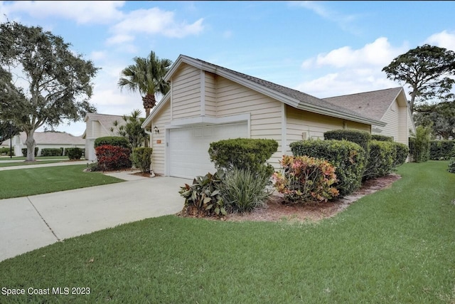 view of property exterior featuring a yard and a garage