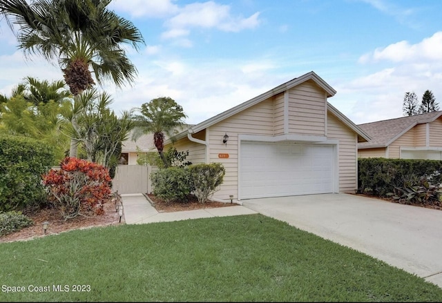 ranch-style home featuring a garage and a front lawn