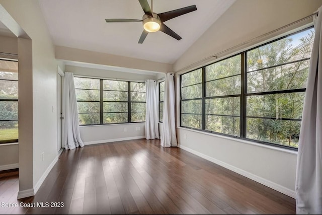 unfurnished sunroom featuring vaulted ceiling, a healthy amount of sunlight, and ceiling fan