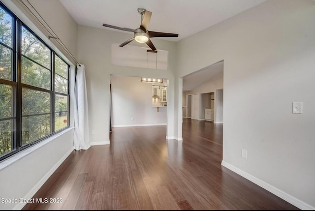 unfurnished room with dark wood-type flooring and ceiling fan