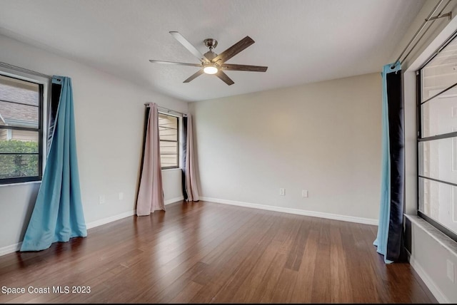 spare room featuring dark hardwood / wood-style floors and ceiling fan