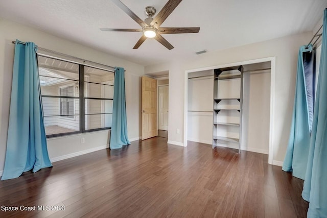 unfurnished bedroom featuring dark wood-type flooring and ceiling fan