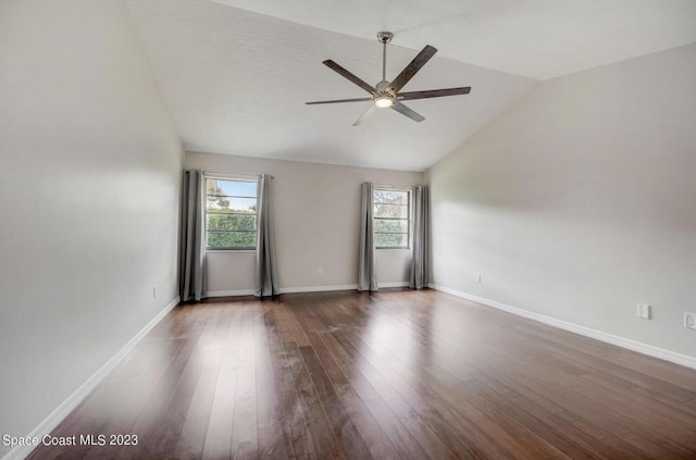 unfurnished room featuring vaulted ceiling, dark hardwood / wood-style floors, and ceiling fan