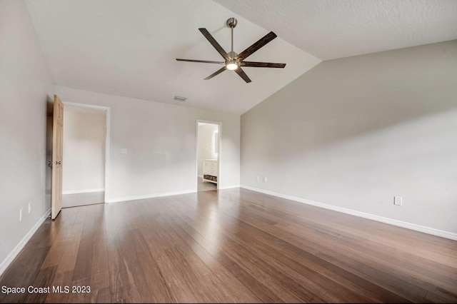 unfurnished room featuring ceiling fan, dark hardwood / wood-style flooring, and vaulted ceiling