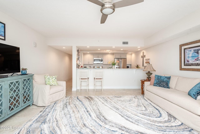 tiled living room featuring ceiling fan