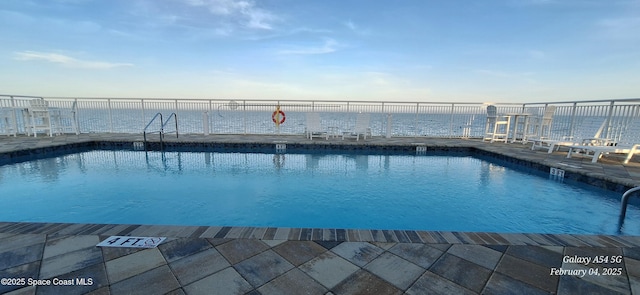 view of pool with a water view