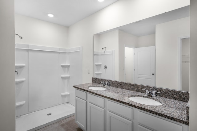 bathroom featuring vanity, tile patterned floors, and walk in shower