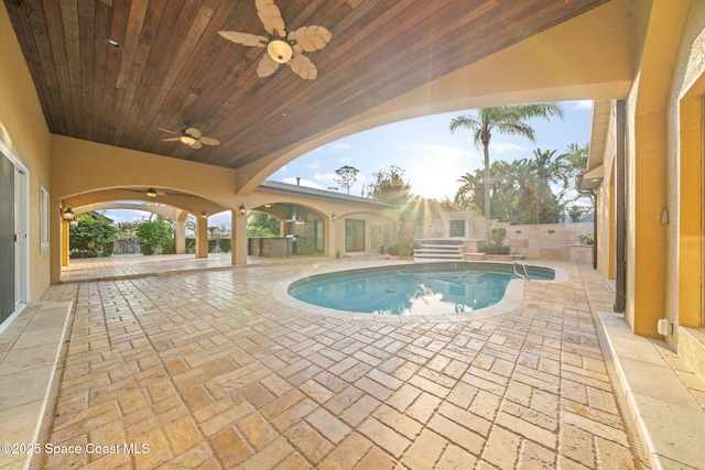 view of pool with a patio area and ceiling fan