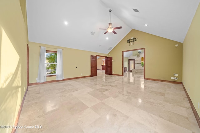 unfurnished living room featuring high vaulted ceiling and ceiling fan