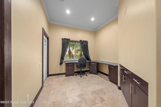 office area with built in desk and ornamental molding