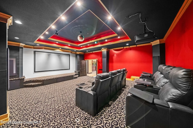 carpeted cinema room featuring a raised ceiling and crown molding